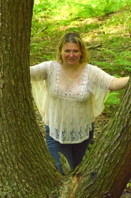 woman standing between trees
