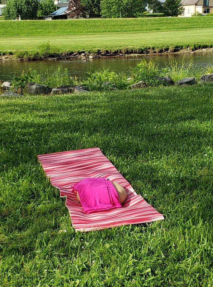 yoga towel and pillow outside on grass